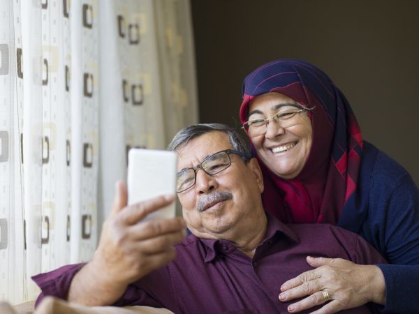 A senior couple looking sat an iphone