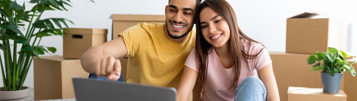 A man and woman in a rental property looking at a laptop