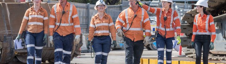 Men and women walking together on a construction site
